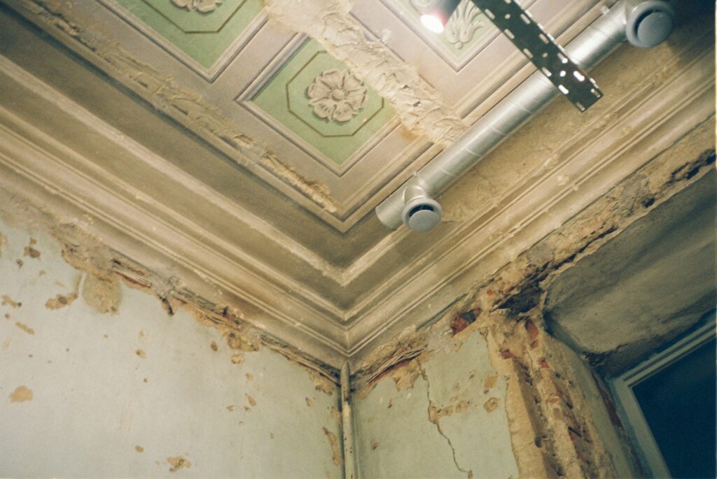 Room ceiling with water damage before restoration
