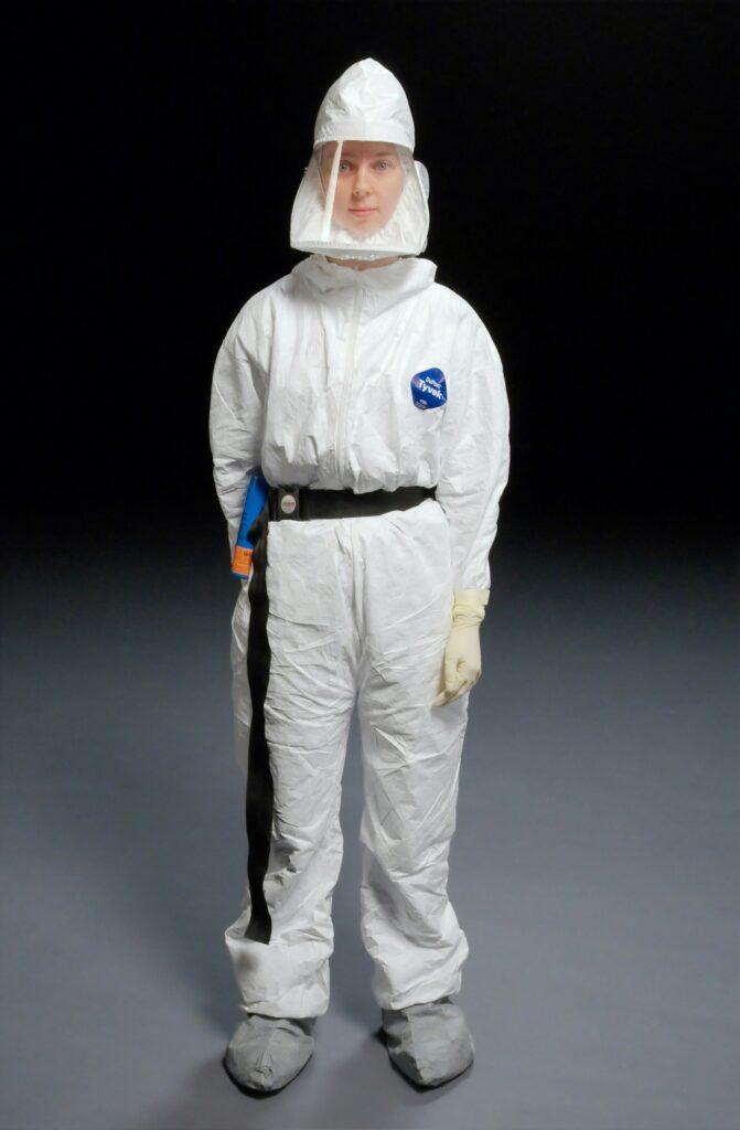 Technician in protective gear for mold remediation